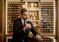 Handsome mature man tasting red wine Royalty Free Stock Photo