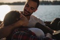 Man hugging and looking his girlfriend by the river Royalty Free Stock Photo