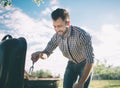 Handsome man preparing barbecue for friends. man cooking meat on barbecue - Chef putting some sausages and pepperoni on Royalty Free Stock Photo