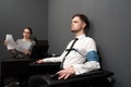 Woman testing man with polygraph in grey room. Royalty Free Stock Photo