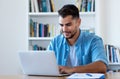 Handsome mexican hipster man sending email with laptop Royalty Free Stock Photo