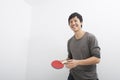 Handsome mid adult man holding table tennis paddle