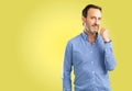 Handsome senior man isolated over yellow background Royalty Free Stock Photo