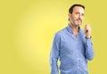 Handsome senior man isolated over yellow background Royalty Free Stock Photo