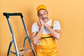 Handsome middle age man with grey hair holding ladder sleeping tired dreaming and posing with hands together while smiling with Royalty Free Stock Photo