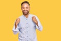 Handsome middle age man wearing business shirt excited for success with arms raised and eyes closed celebrating victory smiling Royalty Free Stock Photo