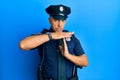 Handsome middle age mature man wearing police uniform doing time out gesture with hands, frustrated and serious face