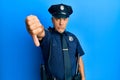 Handsome middle age mature man wearing police uniform looking unhappy and angry showing rejection and negative with thumbs down Royalty Free Stock Photo