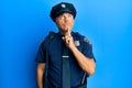 Handsome middle age mature man wearing police uniform thinking concentrated about doubt with finger on chin and looking up