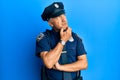 Handsome middle age mature man wearing police uniform thinking worried about a question, concerned and nervous with hand on chin
