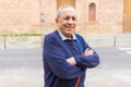 Handsome middle age senior man smiling cheerful, happy and positive with crossed arms at the city town Royalty Free Stock Photo