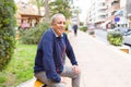 Handsome middle age senior man smiling cheerful, happy and positive sitting at the park Royalty Free Stock Photo