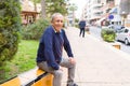 Handsome middle age senior man smiling cheerful, happy and positive sitting at the park Royalty Free Stock Photo