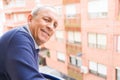 Handsome middle age senior man smiling cheerful, happy and positive by the window, looking for the future Royalty Free Stock Photo