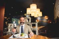 Handsome businessman having lunch and drinking red wine in resta Royalty Free Stock Photo