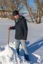 Handsome middle-aged caucasian man cleans snow on household plot Royalty Free Stock Photo