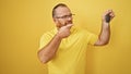 Handsome middle-aged caucasian man, confidently smiling, showing off the key to his new car, joyfully pointing finger, standing Royalty Free Stock Photo