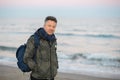 Handsome middle-aged man at the beach. Attractive happy smiling mid adult male model posing at seaside, sunset o sunrise. Outdoor Royalty Free Stock Photo