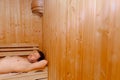 handsome middle aged man lying in electric sauna heater in steam room. relaxation and rest concept, copy space Royalty Free Stock Photo