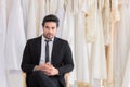Handsome mix race beard groom hold flowers bouquet waiting for bride while fitting wedding dress,. happy smart man with tuxedo Royalty Free Stock Photo