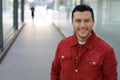 Handsome mixed ethnicity man smiling in urban setting Royalty Free Stock Photo