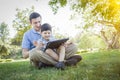 Handsome Mixed Race Father and Son Playing on Computer Tablet Royalty Free Stock Photo