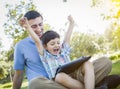 Handsome Mixed Race Father and Son Playing on Computer Tablet Royalty Free Stock Photo