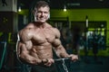 Handsome model young man training arms in gym Royalty Free Stock Photo