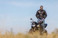 A handsome motorcycle stands on the road with its owner alone Royalty Free Stock Photo