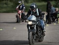 Handsome motorcyclist in black riding his super sport motorcycle. Soft focus. Lens flare 05-08-2019 Riga, Latvia