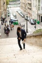 Mulatto guy walking down steps with newspaper. Royalty Free Stock Photo