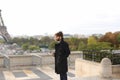 Arabian boy walking near Eiffel Tower with smartphone in slow mo Royalty Free Stock Photo