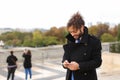 Arabian boy walking near Eiffel Tower with smartphone in slow mo Royalty Free Stock Photo