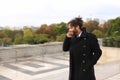 Arabian boy walking near Eiffel Tower with smartphone in slow mo Royalty Free Stock Photo