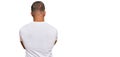 Handsome muscle man wearing casual white tshirt standing backwards looking away with crossed arms