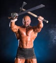 Handsome muscular ancient warrior with axe and sword Royalty Free Stock Photo