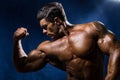 Handsome muscular bodybuilder demonstrates his muscles Royalty Free Stock Photo