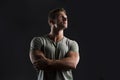 Handsome muscular fit young man on dark background looking up Royalty Free Stock Photo