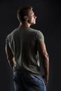 Handsome muscular fit young man's back on dark background Royalty Free Stock Photo