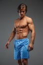 Handsome muscular guy in blue shorts. Royalty Free Stock Photo