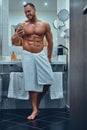 A handsome muscular male in stylish twin bathroom.