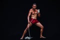 Handsome Muscular Man displays ancient Asian traditional martial arts, Thai Boxing or Muay Thai Royalty Free Stock Photo