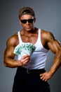 Handsome muscular man with euro banknotes in hand. Royalty Free Stock Photo