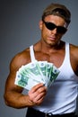 Handsome muscular man with euro banknotes in hand. Royalty Free Stock Photo