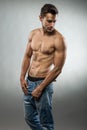 Handsome muscular man posing half naked