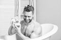 Handsome muscular man relaxing bathtub. Warm bath concept. Transform your bathroom into own private spa. Macho with Royalty Free Stock Photo