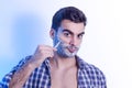 Handsome muscular man shaving with metal razor Royalty Free Stock Photo