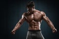Handsome muscular man on wall background, shaped abdominal. Strong male naked torso abs