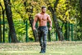 Handsome Muscular Shirtless Hunk Man Outdoor in outdoor Setting. Showing Healthy Body. Halfnaked sportsman. Park view. Royalty Free Stock Photo