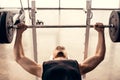 handsome muscular sportsman lifting barbell